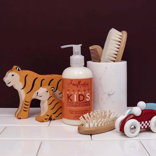 Après-shampoing Shea Moisture Kids - Mango & Carrot Conditioner avec du Beurre de Mangue et de l’huile de Carotte.