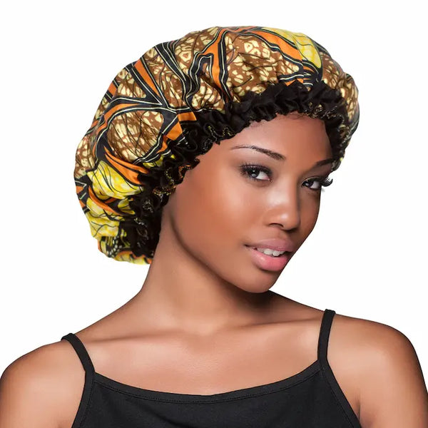 Un bonnet de nuit en satin pour proteger vos cheveux. Réversible imprimé Sahara d'un coté, noir de l'autre.
